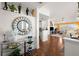Open-concept foyer leading into a living area, showcasing hardwood floors and stylish decor at 7501 S Addison Way, Aurora, CO 80016