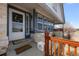 Close up of a charming front porch with a white door and an inviting 'welcome' mat at 7501 S Addison Way, Aurora, CO 80016