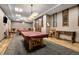 Recreation room with pool tables covered in red, chairs and tables throughout the space, and wood floors at 7501 S Addison Way, Aurora, CO 80016