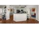 Modern kitchen with a breakfast bar that opens to the living spaces and features hardwood floors at 7501 S Addison Way, Aurora, CO 80016