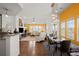 Bright and airy living space open to the kitchen and dining area with hardwood floors at 7501 S Addison Way, Aurora, CO 80016