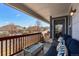 Cozy covered patio with cushioned seating, a glass-top table, and scenic neighborhood views at 7501 S Addison Way, Aurora, CO 80016