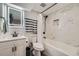 Updated bathroom features marble-style tile, modern vanity with lighted mirror, and tub with matte black hardware at 10541 Routt St, Westminster, CO 80021