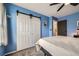 Bedroom featuring blue walls, plush carpeting, and sliding door closet at 10541 Routt St, Westminster, CO 80021