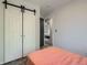 Bedroom featuring large closet with sliding doors and view to connected room at 10541 Routt St, Westminster, CO 80021