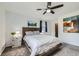 Bright bedroom featuring soft carpet, side tables with lamps, and a large ceiling fan at 10541 Routt St, Westminster, CO 80021