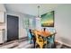 Dining room features a rustic wood table, colorful chairs, and modern light fixture at 10541 Routt St, Westminster, CO 80021