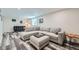 Spacious living room featuring hardwood-style flooring and modern furnishings at 10541 Routt St, Westminster, CO 80021