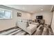 Living room with a large sectional sofa, stylish wood floors, and a window at 10541 Routt St, Westminster, CO 80021