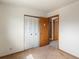 Bedroom showing a closet, doorway, and neutral-toned walls and carpet at 760 Century Pl # A, Monument, CO 80132