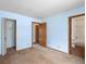 A corner view shows this bedroom features light blue walls and access to a bath and closet at 760 Century Pl # A, Monument, CO 80132