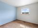 Carpeted bedroom showcasing a window, blue accent wall, and baseboard heating at 760 Century Pl # A, Monument, CO 80132