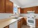 Traditional kitchen with wooden cabinets, white appliances and a window view at 760 Century Pl # A, Monument, CO 80132