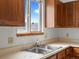 Traditional kitchen with stainless steel sink beneath window with blue sky view at 760 Century Pl # A, Monument, CO 80132