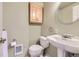 Small bathroom with pedestal sink, toilet and overhead cabinet at 15843 E 13Th Ave, Aurora, CO 80011