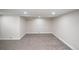 Spacious carpeted basement with neutral paint and updated lighting at 2504 S Yates St, Denver, CO 80219