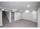 A finished basement offers a large rec area, carpet, and access to the utility room and stairs at 2504 S Yates St, Denver, CO 80219