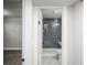 This recently renovated bathroom has a tiled shower with a bench and a marble floor at 2504 S Yates St, Denver, CO 80219