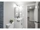 This bathroom features white marble flooring, a modern vanity, and a sleek mirror at 2504 S Yates St, Denver, CO 80219