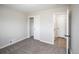 Bedroom with neutral paint, new carpet, closet and easy access to the bathroom at 2504 S Yates St, Denver, CO 80219