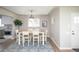Dining room features modern table and chairs plus a beautiful blue rug at 2504 S Yates St, Denver, CO 80219