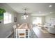 Open-concept dining room and living room, perfect for entertaining and modern living at 2504 S Yates St, Denver, CO 80219