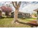 Charming single-story home with a well-kept lawn and mature trees at 2504 S Yates St, Denver, CO 80219