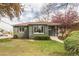 Charming single story home showcasing a lush front yard and inviting curb appeal at 2504 S Yates St, Denver, CO 80219