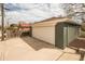 View of detached brick garage with concrete driveway at 2504 S Yates St, Denver, CO 80219