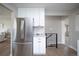 Renovated kitchen features a stainless steel refrigerator and adjacent breakfast bar at 2504 S Yates St, Denver, CO 80219