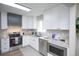 Well-equipped kitchen boasts stainless steel appliances and white cabinetry at 2504 S Yates St, Denver, CO 80219