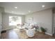 Bright living room featuring neutral decor, hardwood floors, and lots of natural light at 2504 S Yates St, Denver, CO 80219