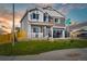 Inviting two-story home featuring a well-manicured lawn, stone accents, and a covered porch, creating a warm and welcoming facade at 716 N Carrie Ct, Watkins, CO 80137