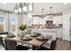 Open-concept kitchen and dining area with stylish lighting and modern decor at 716 N Carrie Ct, Watkins, CO 80137