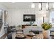 Inviting living room featuring stylish decor, hardwood floors, and seamless flow into the dining area, perfect for entertaining at 716 N Carrie Ct, Watkins, CO 80137