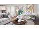 Cozy living room featuring a round wood table, comfortable seating, and stylish decor, creating a warm and inviting atmosphere at 716 N Carrie Ct, Watkins, CO 80137