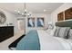 Inviting main bedroom featuring accent wall, stylish chandelier, and comfortable seating area at 716 N Carrie Ct, Watkins, CO 80137
