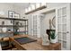 Inviting home office featuring a large wooden desk, built-in shelving, and a stylish light fixture, perfect for remote work at 716 N Carrie Ct, Watkins, CO 80137