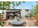 Landscaped backyard featuring a gazebo with fireplace and fountain, creating an inviting outdoor space at 4218 S Alton St, Greenwood Village, CO 80111