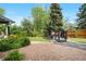 Backyard patio with artificial grass, beautiful landscaping, and a lovely wooden deck at 4218 S Alton St, Greenwood Village, CO 80111