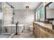 Modern bathroom featuring a soaking tub, glass shower, and vanity with double sinks at 4218 S Alton St, Greenwood Village, CO 80111