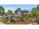 Beautifully landscaped home with manicured lawn and mature trees, showcasing curb appeal and inviting charm at 4218 S Alton St, Greenwood Village, CO 80111