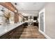Modern kitchen with dark cabinetry, stainless steel appliances, and open view to the living room at 4218 S Alton St, Greenwood Village, CO 80111