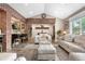 Open-concept living room with brick accents, connecting seamlessly to kitchen and staircase at 4218 S Alton St, Greenwood Village, CO 80111