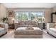 Cozy living room featuring neutral tones, large windows, and comfortable seating, creating an inviting atmosphere at 4218 S Alton St, Greenwood Village, CO 80111
