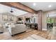Open-concept living area featuring exposed brick, wood floors, and seamless flow to the kitchen at 4218 S Alton St, Greenwood Village, CO 80111