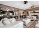 Inviting living area with exposed brick, modern lighting, and view to kitchen area at 4218 S Alton St, Greenwood Village, CO 80111