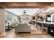 Spacious living area featuring exposed brick, wood floors, and large window for natural light at 4218 S Alton St, Greenwood Village, CO 80111
