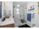 Modern bathroom featuring a glass-enclosed shower, vessel sink, and neutral color palette at 4389 S Sherman St, Englewood, CO 80113