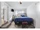 Comfortable bedroom featuring carpet, a television, and a metal frame bed at 4389 S Sherman St, Englewood, CO 80113